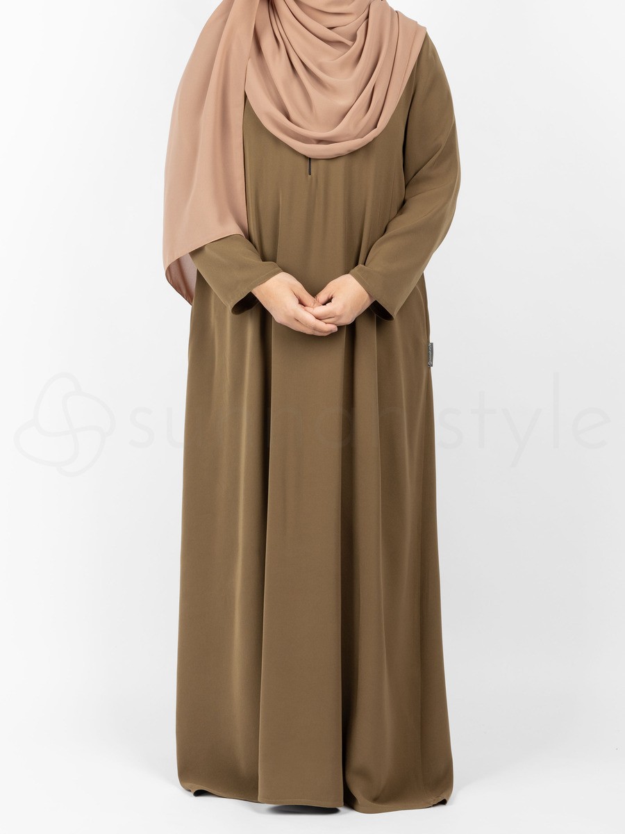 Comfortable and functional, unlined beige abaya with snaps on the